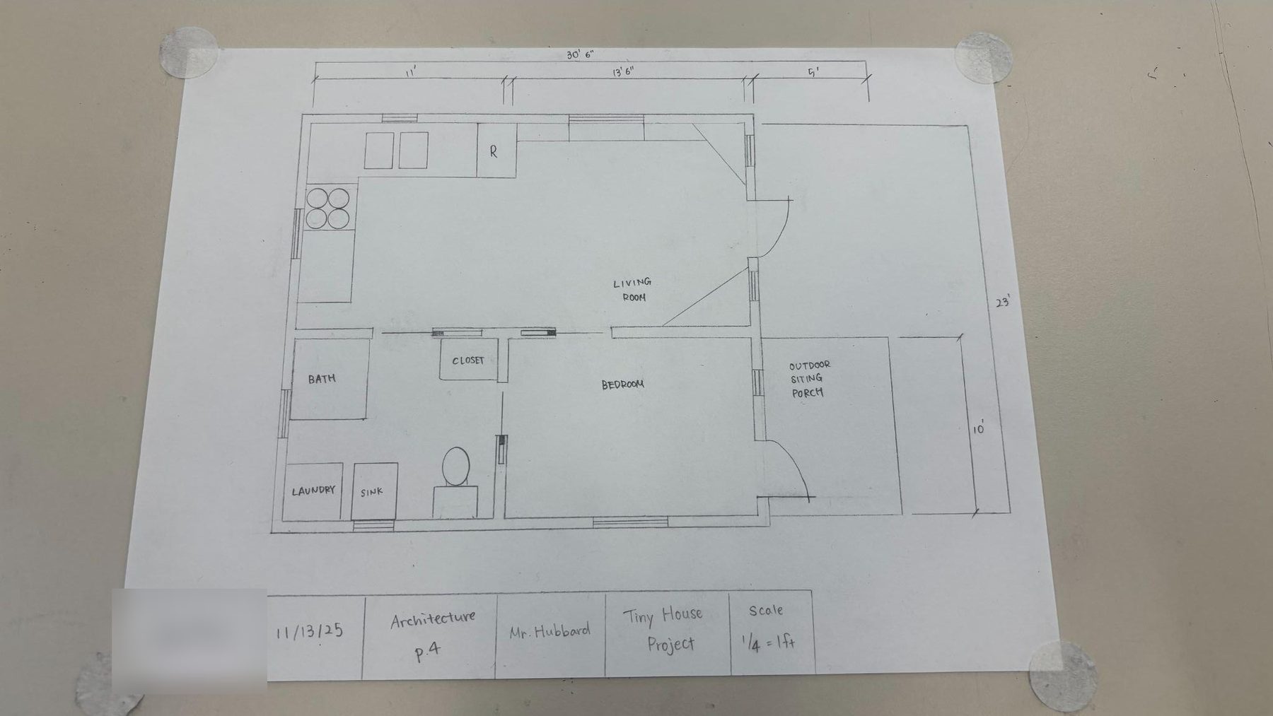 A student floor plan with a kitchen, living room, bedroom, bathroom, closet and an outdoor sitting porch, dimension strings along the top and right, and a boxed title block along the bottom
