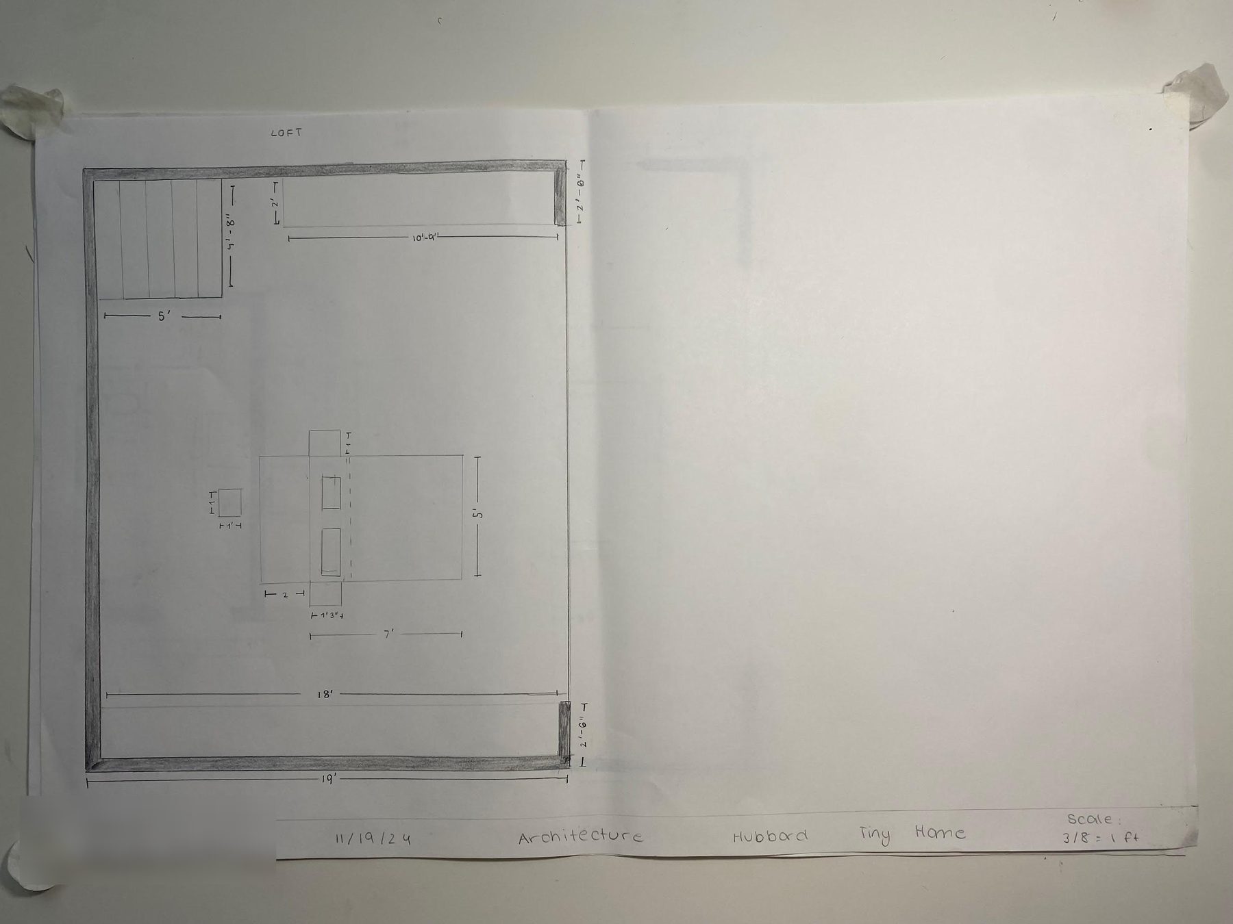 A student loft plan showing the outline of the loft with shaded walls, the stairs in one corner, a bed with side tables, and dimensions