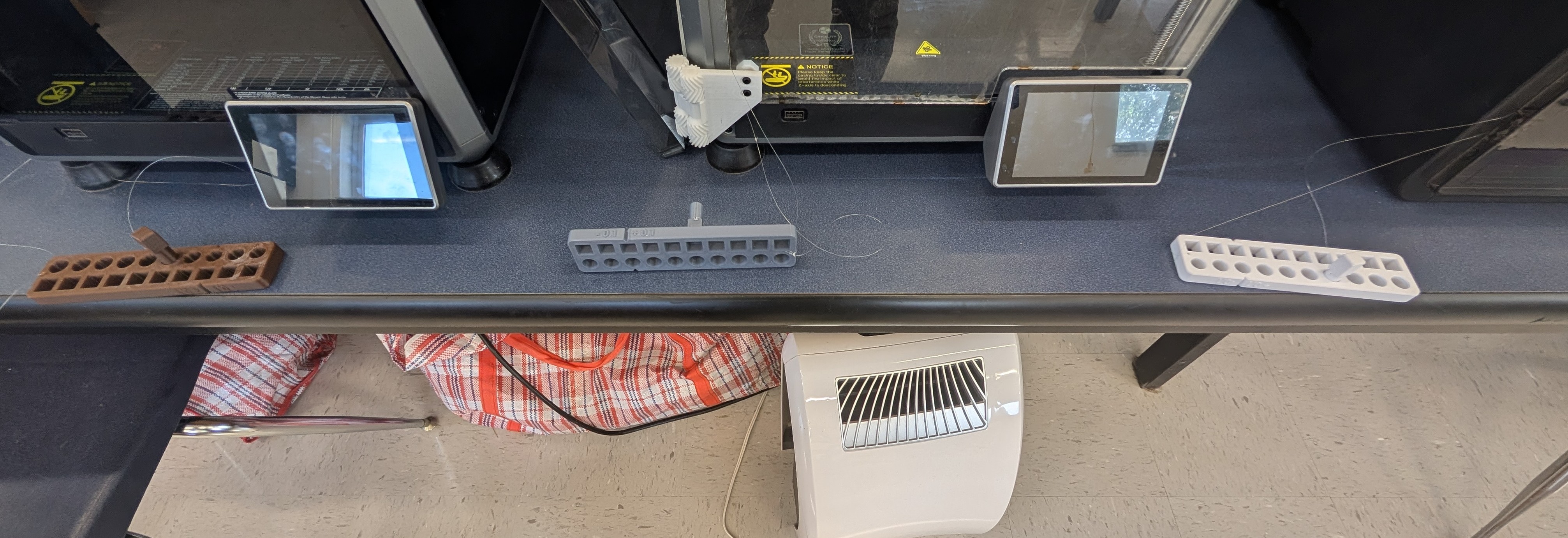 The 3D Printer Tolerance Blocks next to a printer